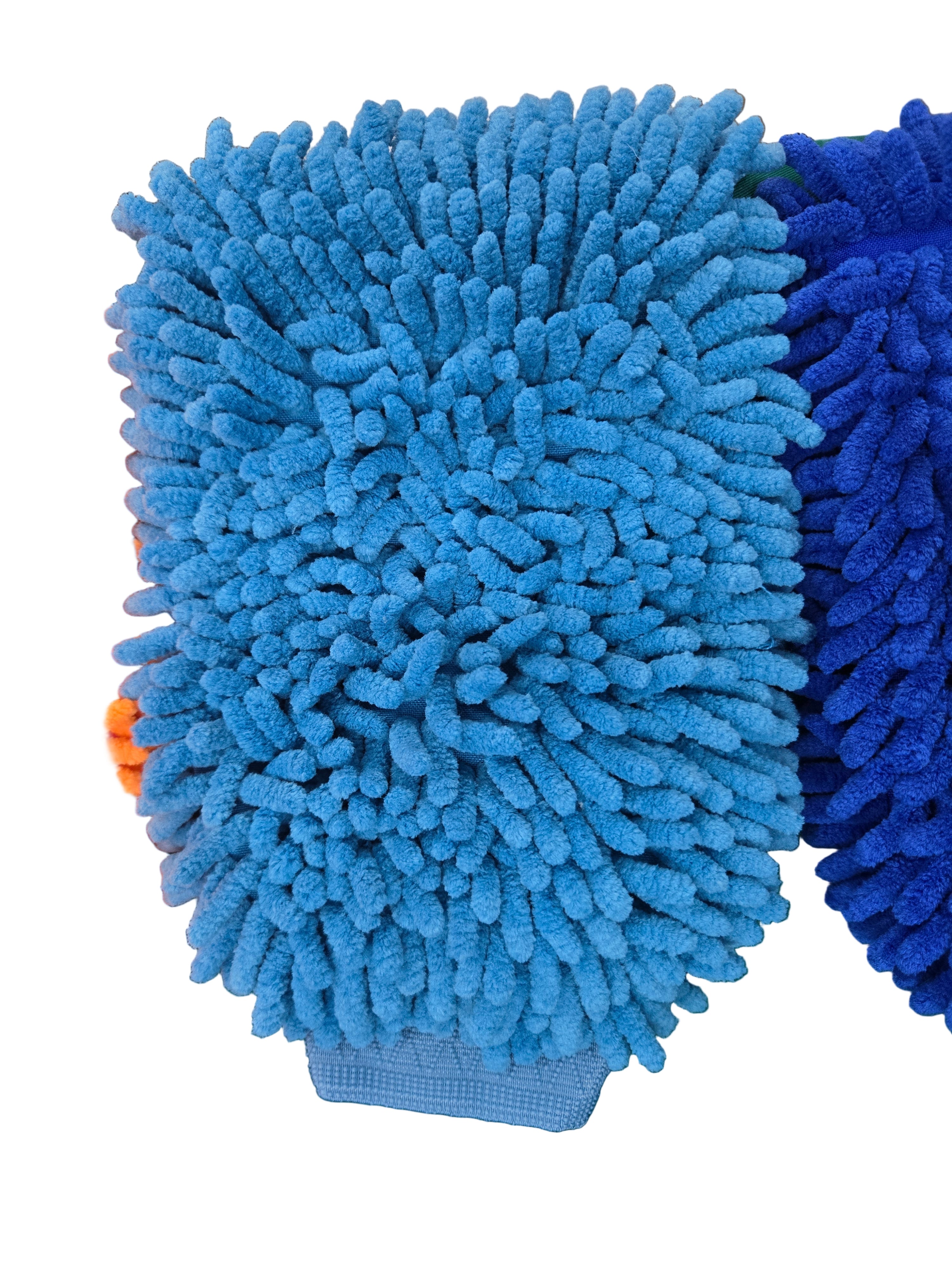 Blue and orange microfiber cleaning pads on a green surface